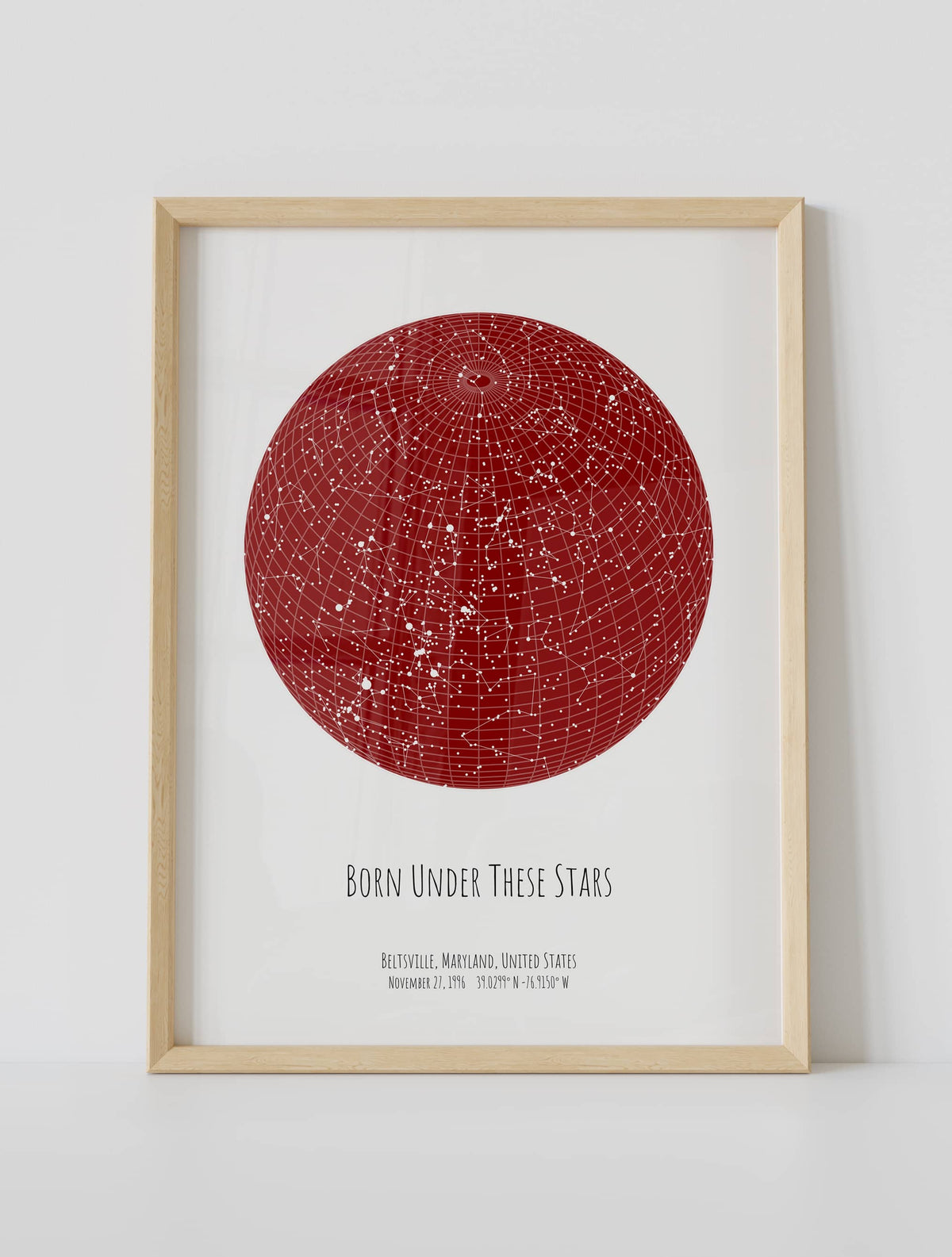 A framed custom star map poster featuring a specific date and location, customized with the quote "Born under these stars"