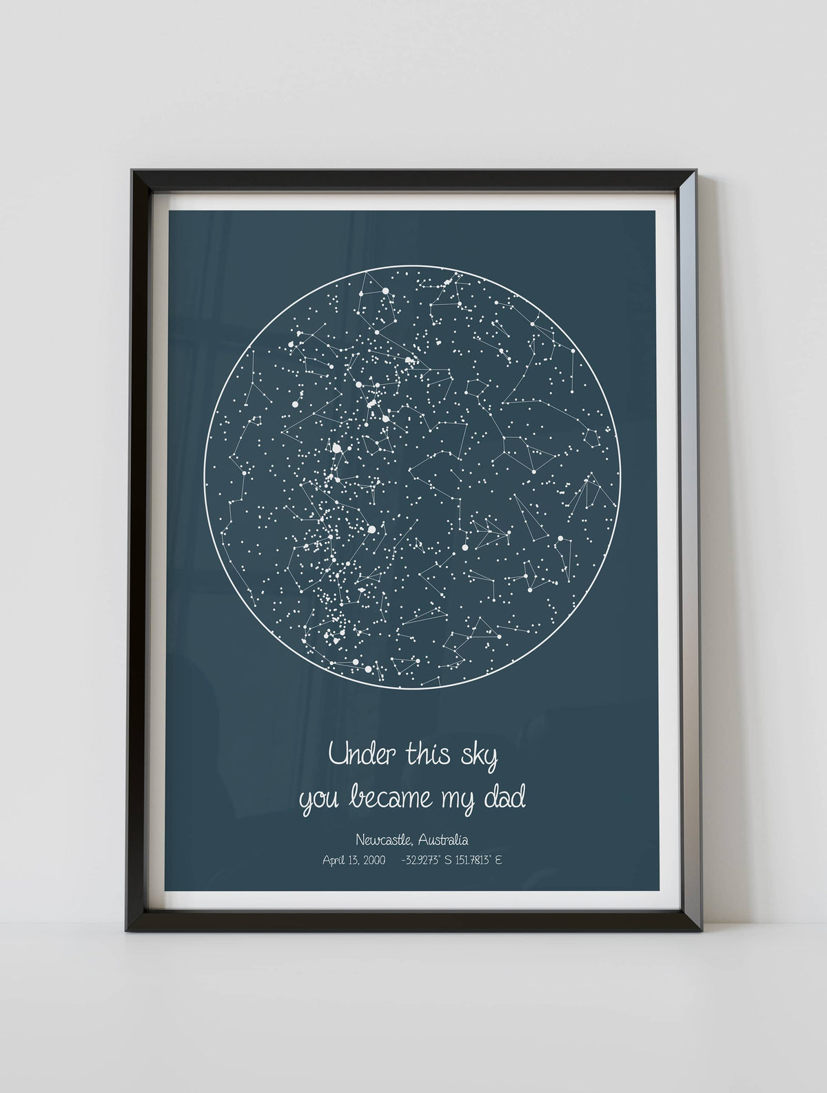 A framed custom star map poster featuring a specific date and location, customized with the quote "Under this sky you became my dad"