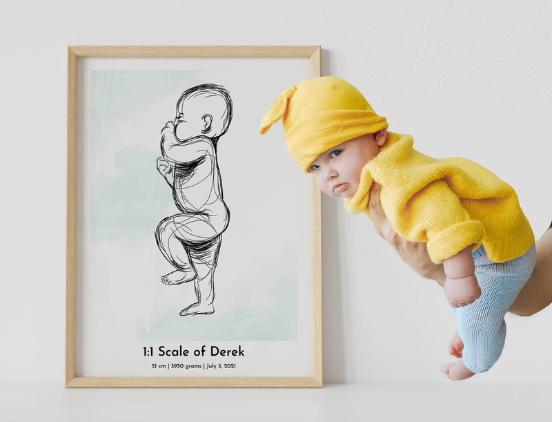 A framed poster of a custom 1:1 scale baby birth poster with a baby dressed in yellow