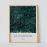 A framed green constellation map poster, with a personalized quote "Under these stars Our journey began"