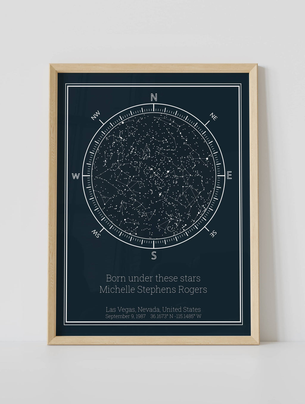 A framed custom star map poster featuring a specific date and location, customized with the quote "Born under these stars"