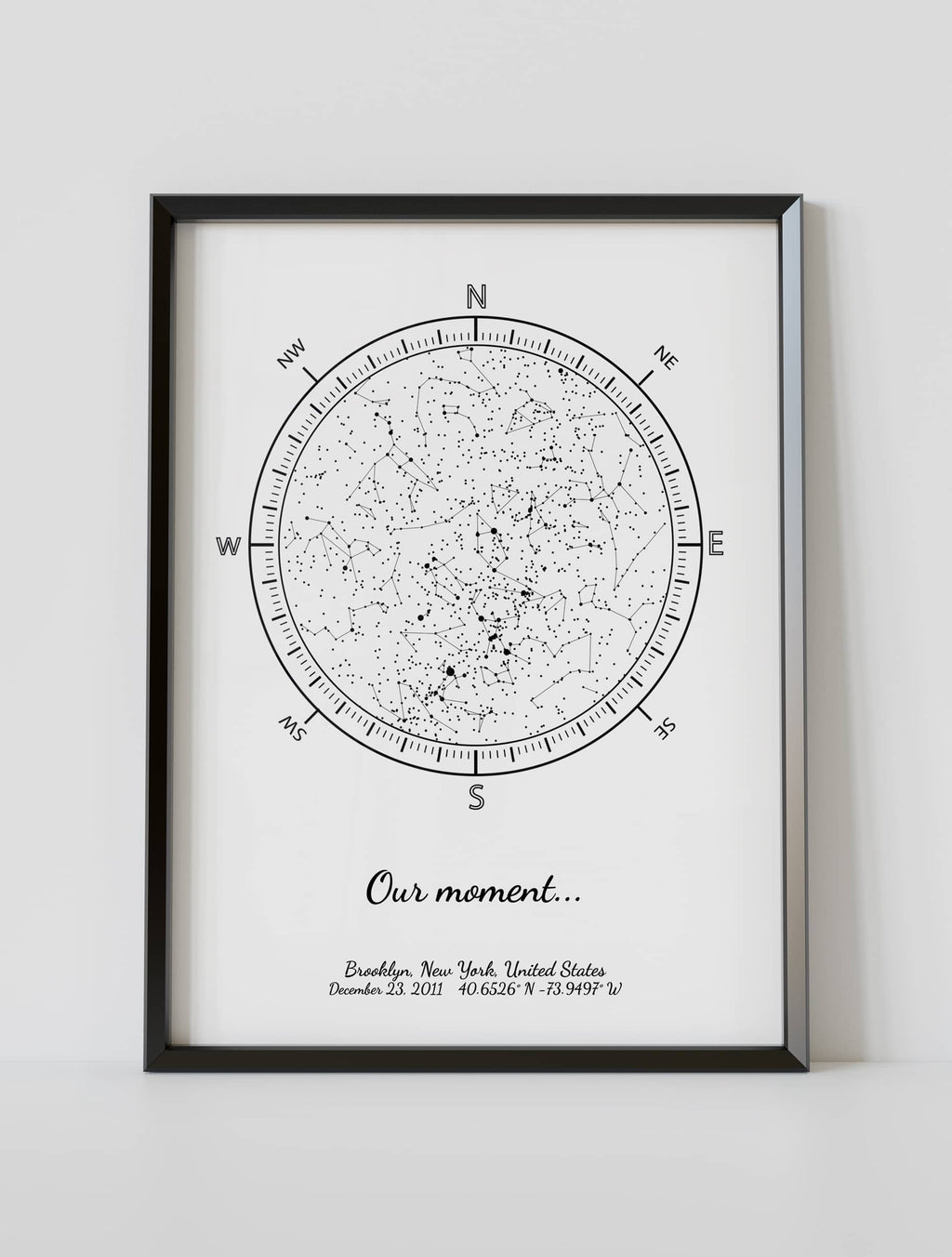 A framed custom star map poster featuring a specific date and location, customized with the quote "Our moment"