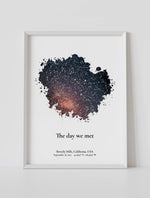 A framed custom star map poster featuring a specific date and location, customized with the quote "The day we met"